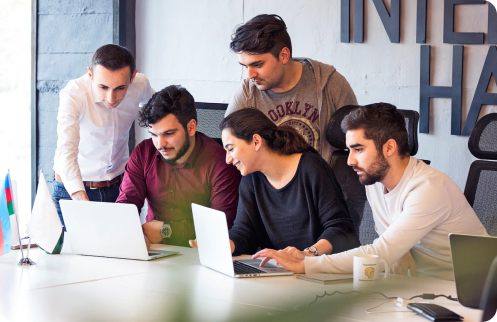 Team Members having discussion with their laptops